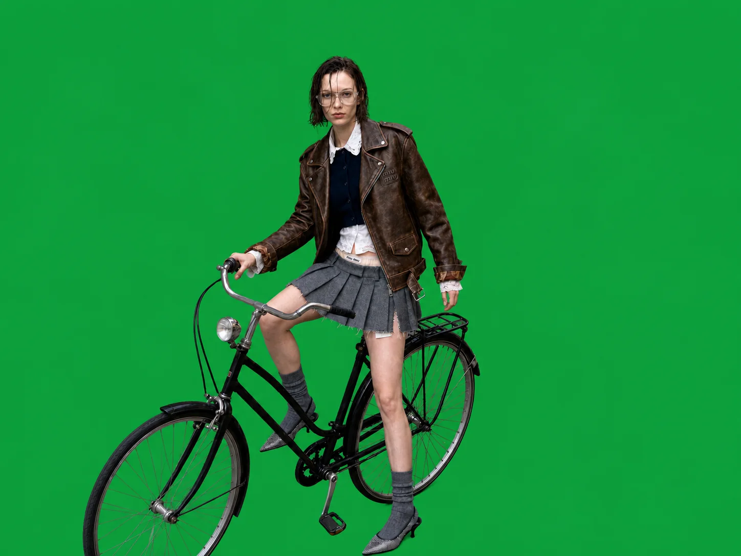 The same frame with the street removed, leaving the rider on a green screen
